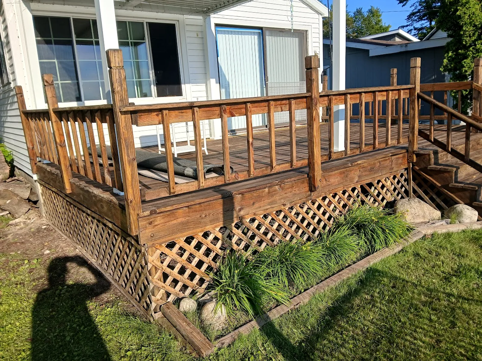 Covered porch and deck area with wood railings
