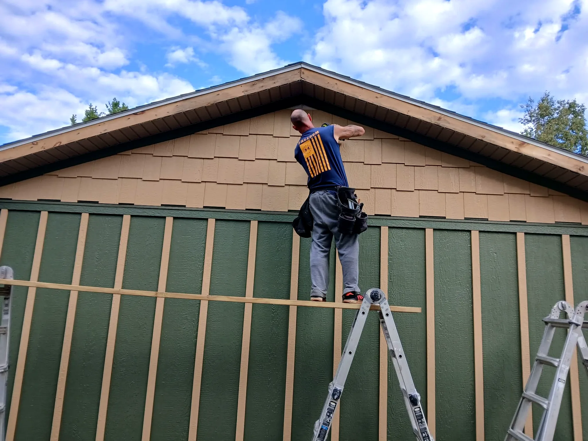 Charles Jones Custom Construction working on soffit and exterior gable details in Northeast Michigan