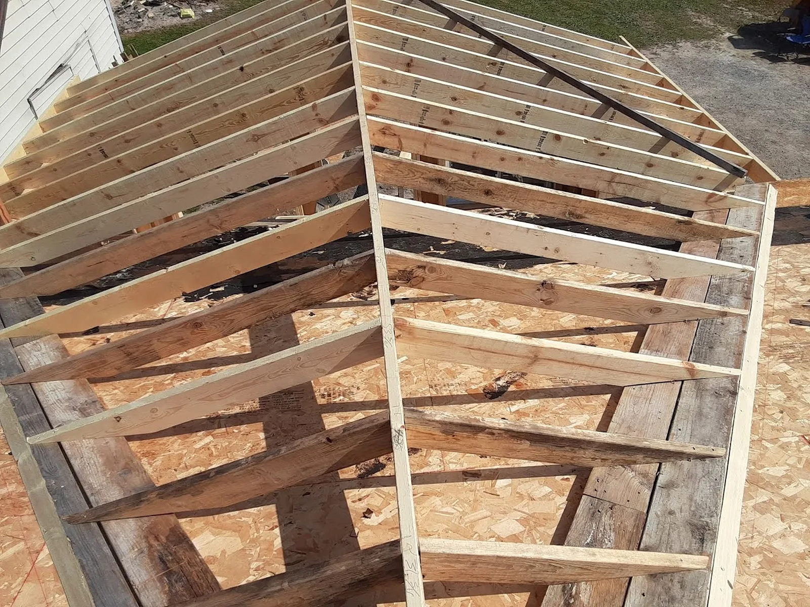Roof framing structure with rafters in progress